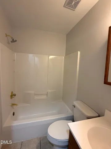 a bathroom with a toilet and a bathtub