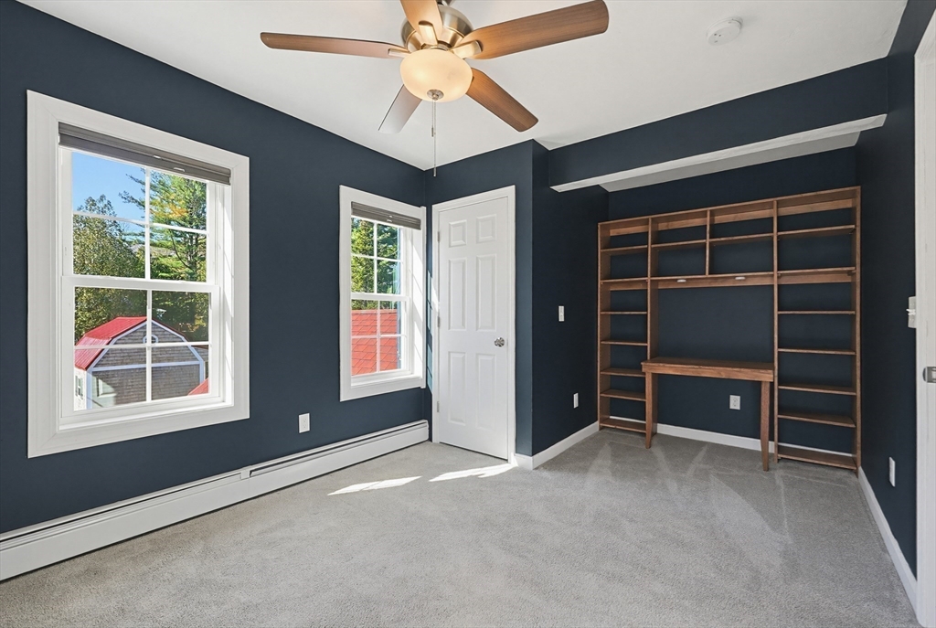 44 Clark Street Spencer, MA 01562 - Photo 22 of 41 a view of an empty room with a window and a ceiling fan