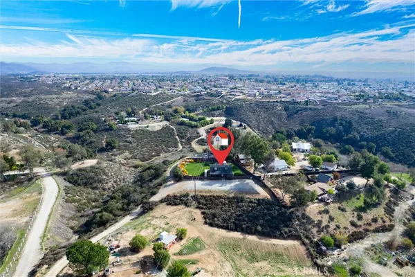 an aerial view of a house with a backyard