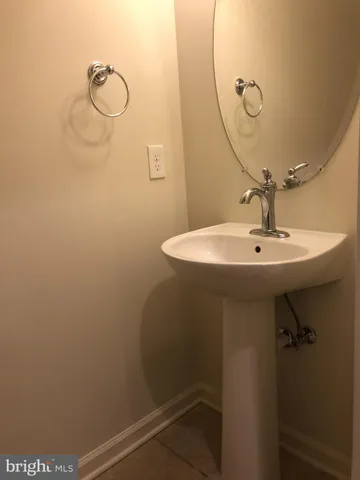 a bathroom with a sink a mirror and shower
