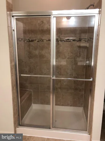a bathroom with a glass shower door