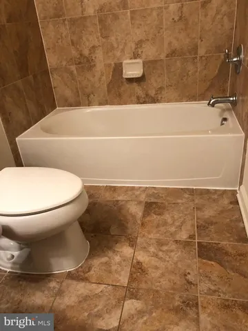 a bathroom with a toilet and a bathtub