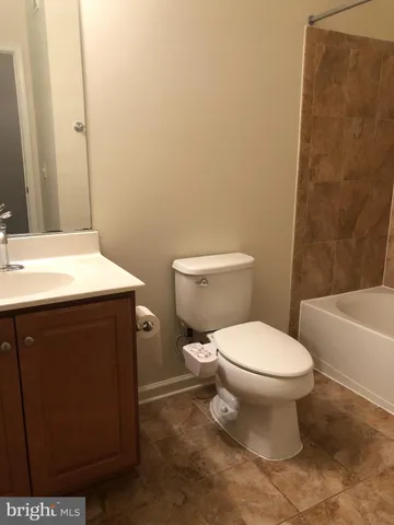 a bathroom with a toilet a sink and a bathtub