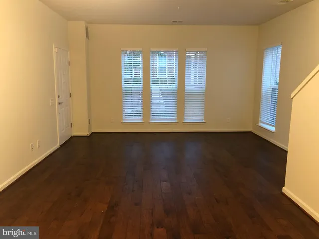 a view of wooden floor and windows in a room