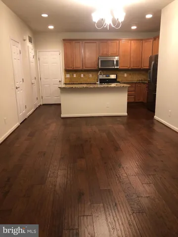a view of kitchen with wooden floor