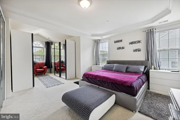 a bedroom with a bed and glass door