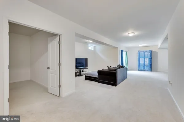 a living room with a couch and a wooden floor