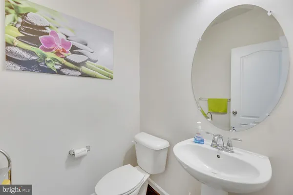 a bathroom with a sink mirror and toilet