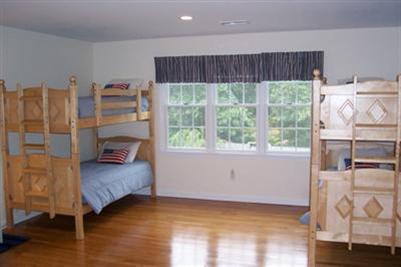 9 Shady Lane Chatham, MA 02633 - Photo 11 of 19 a bedroom with a bed and wooden floor