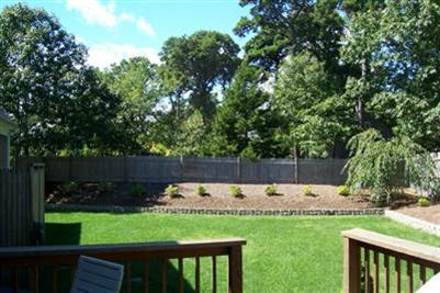 9 Shady Lane Chatham, MA 02633 - Photo 14 of 19 a view of a backyard with large trees and wooden fence