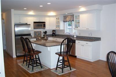 9 Shady Lane Chatham, MA 02633 - Photo 6 of 19 a kitchen with stainless steel appliances granite countertop a stove a refrigerator a sink a table and chairs