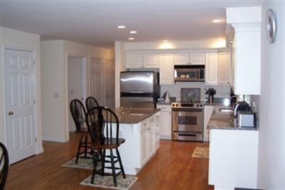 9 Shady Lane Chatham, MA 02633 - Photo 7 of 19 a kitchen with kitchen island a appliances dining table and chairs