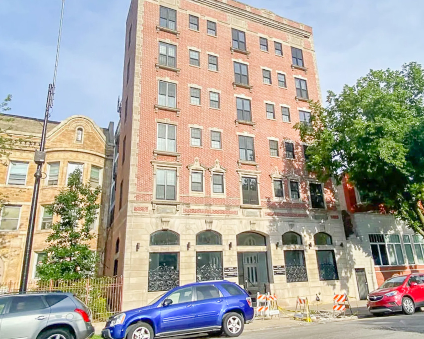 4526 North Sheridan Road, Unit 303 Chicago, IL 60640 - Photo 1 of 14 a front view of a building with lot of cars parked