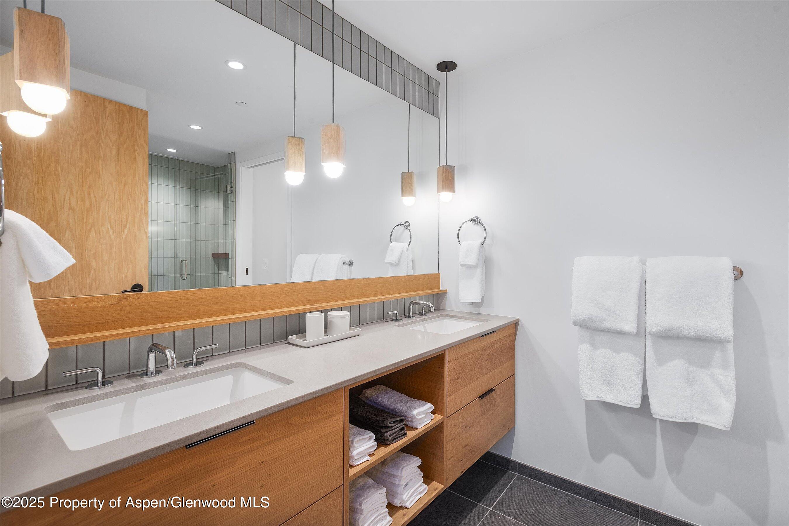 119 Wood Road, Unit 101 Snowmass Village, CO 81615 - Photo 16 of 34 a bathroom with a sink and a mirror