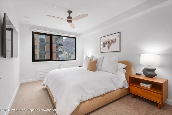 a bedroom with a bed and window