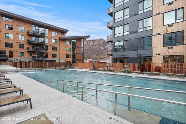 a view of a swimming pool with outdoor seating