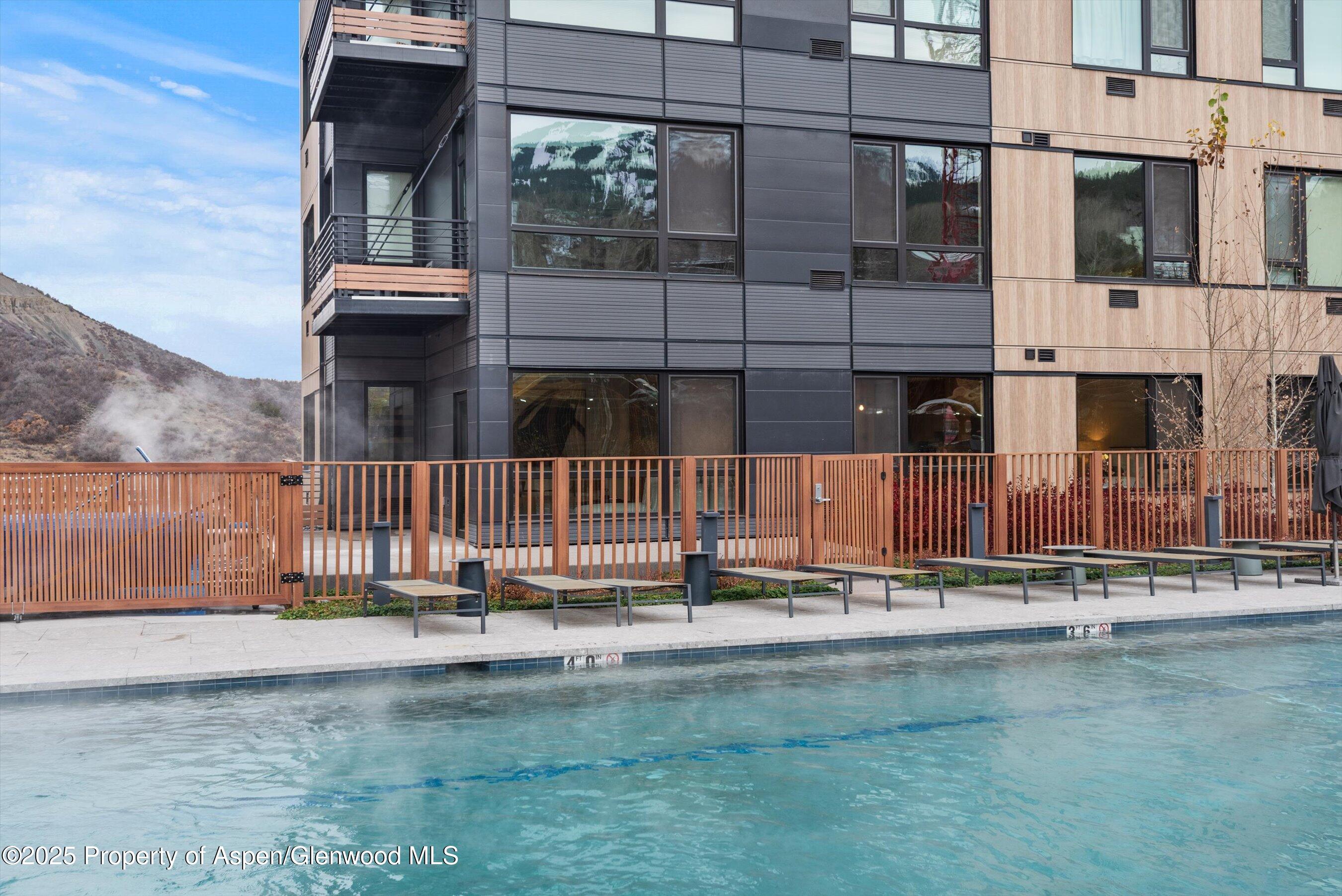 119 Wood Road, Unit 101 Snowmass Village, CO 81615 - Photo 32 of 34 a backyard of a building