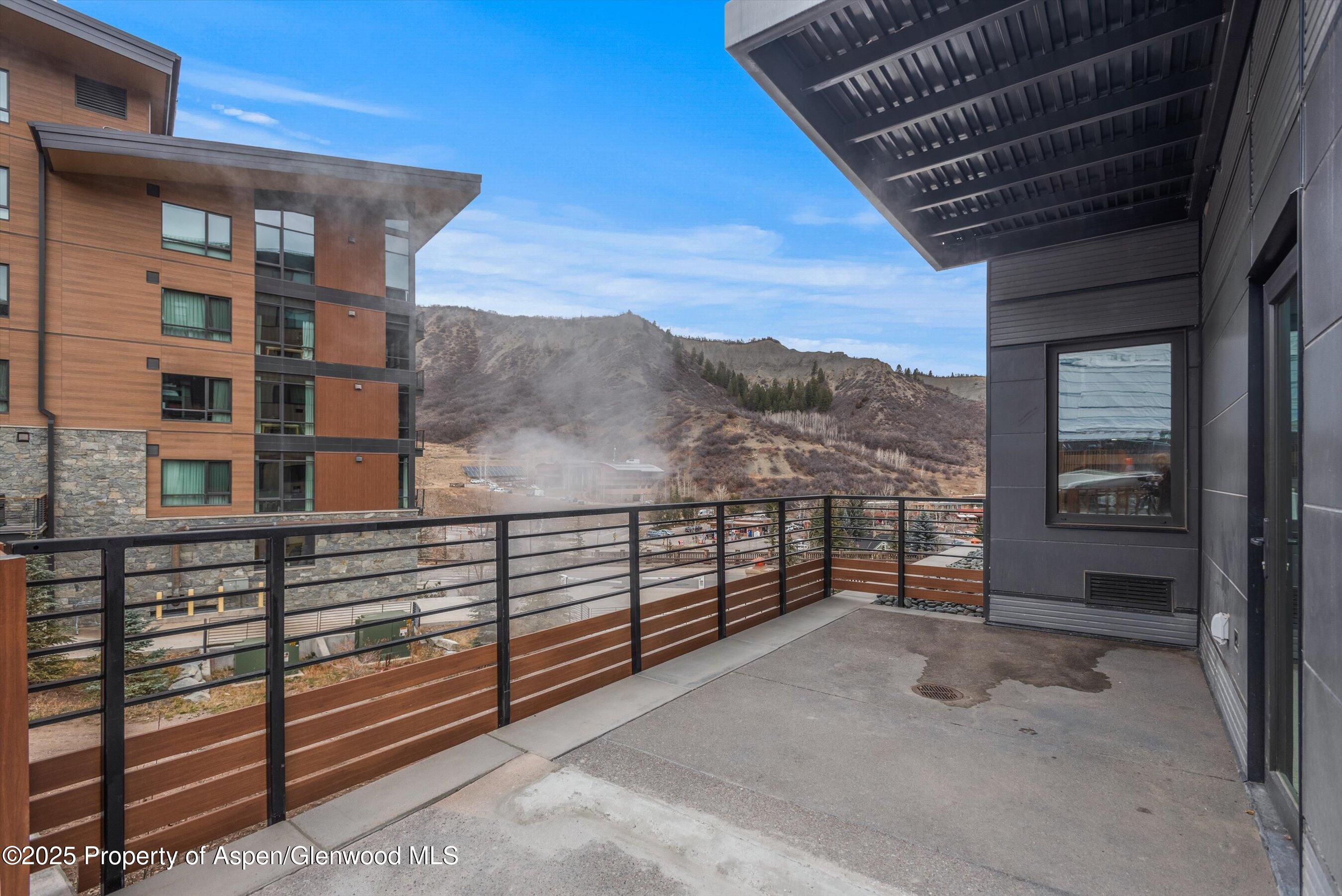 119 Wood Road, Unit 101 Snowmass Village, CO 81615 - Photo 33 of 34 a view of a balcony with a floor to ceiling window and stairs