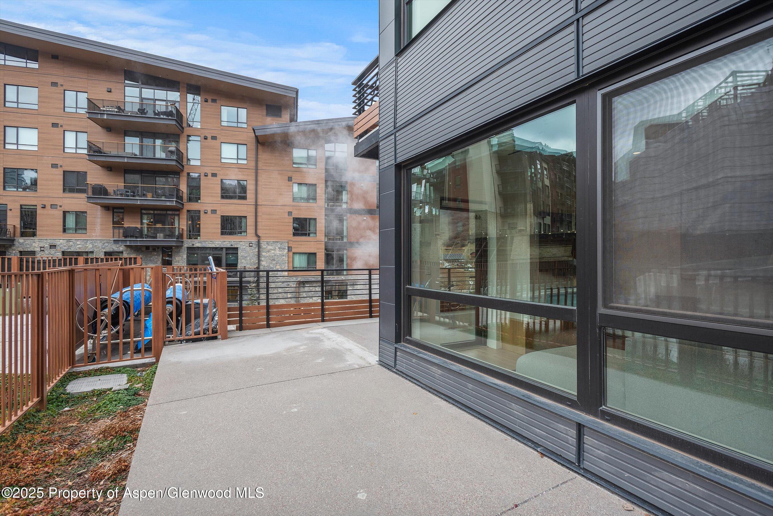 119 Wood Road, Unit 101 Snowmass Village, CO 81615 - Photo 34 of 34 a view of a brick building with a glass door