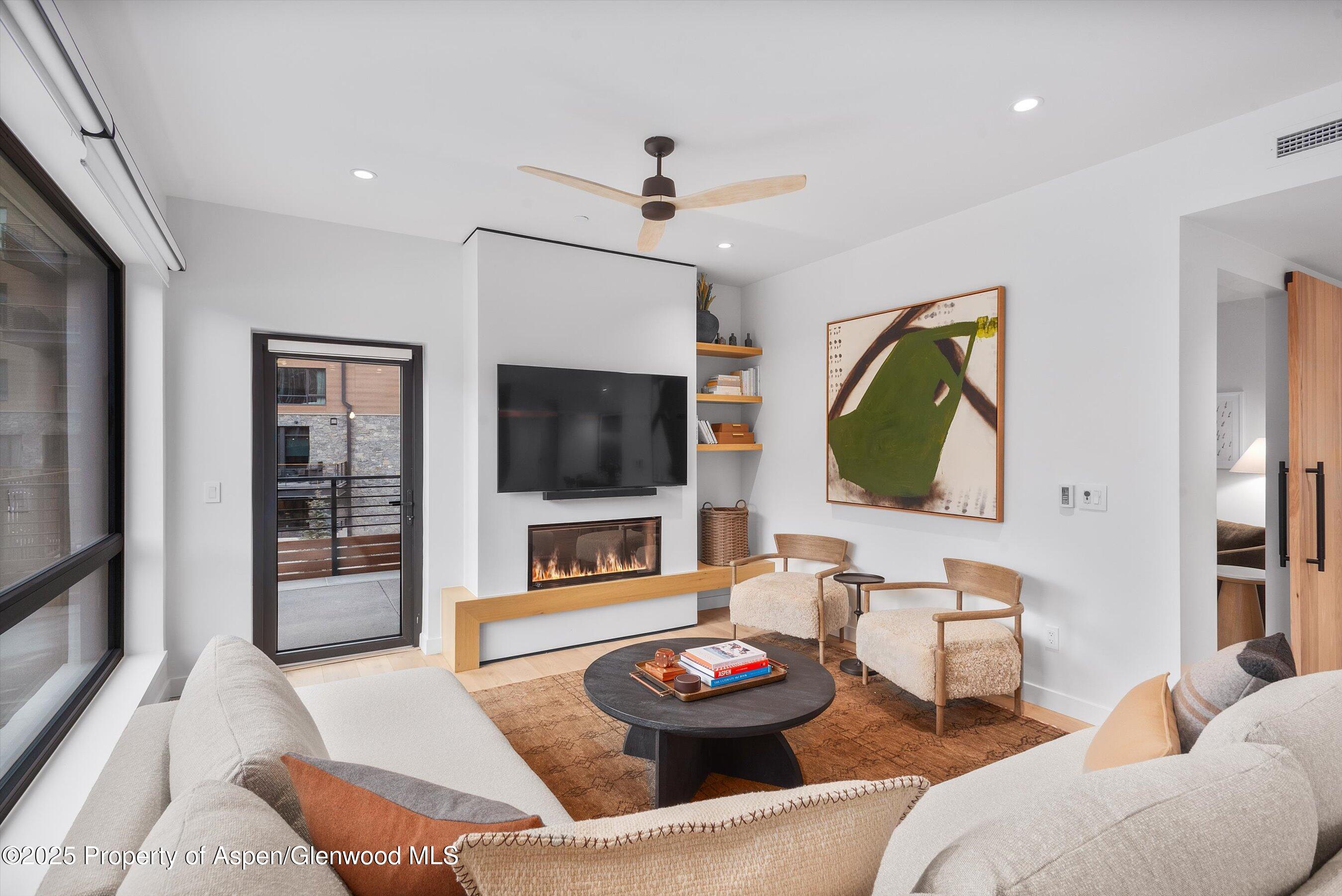 119 Wood Road, Unit 101 Snowmass Village, CO 81615 - Photo 6 of 34 a living room with furniture and a flat screen tv