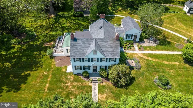 a aerial view of a house with swimming pool next to a yard