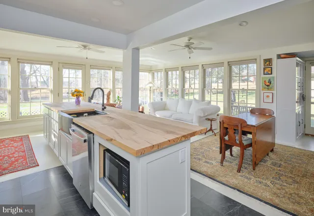 an empty room with a windows and cabinet