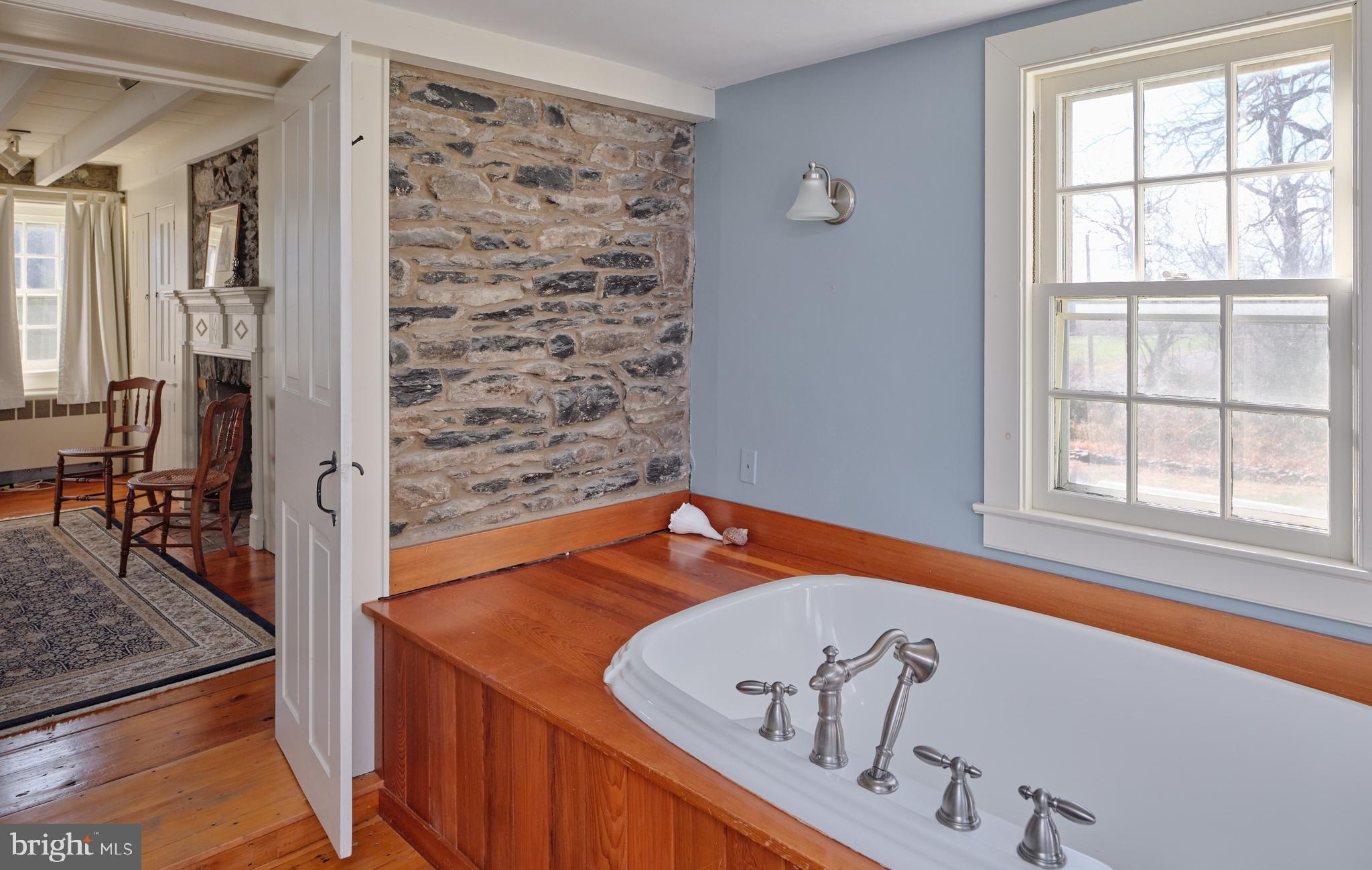 4936 Curly Hill Road Doylestown, PA 18902 - Photo 31 of 102 a view of a bathroom with a tub and a window