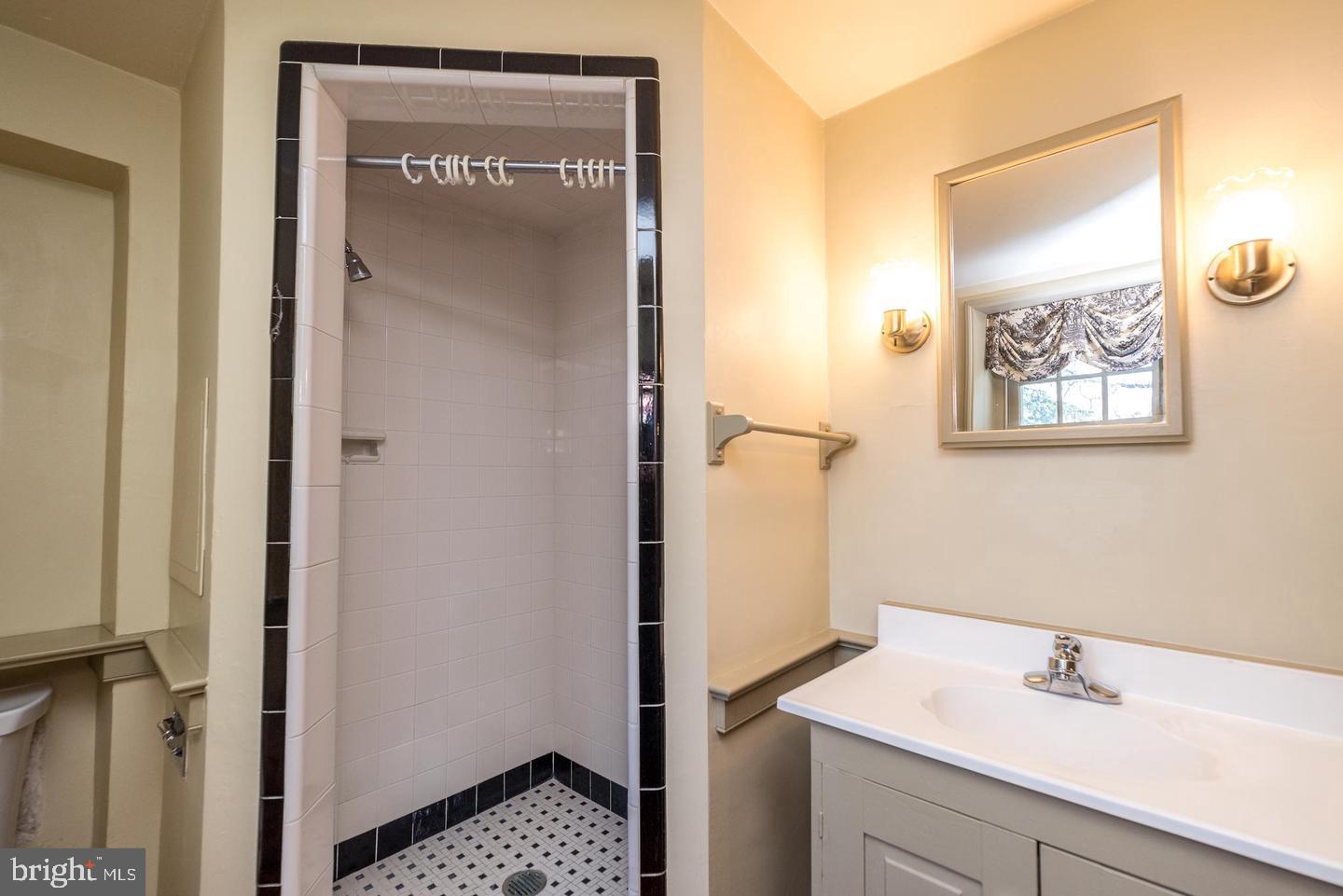 4936 Curly Hill Road Doylestown, PA 18902 - Photo 39 of 102 a bathroom with a sink and a mirror