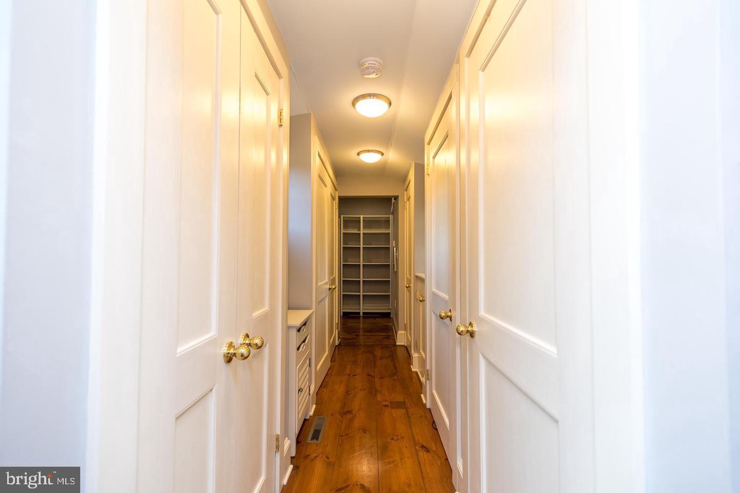 4936 Curly Hill Road Doylestown, PA 18902 - Photo 41 of 102 a view of a hallway with wooden floor and staircase