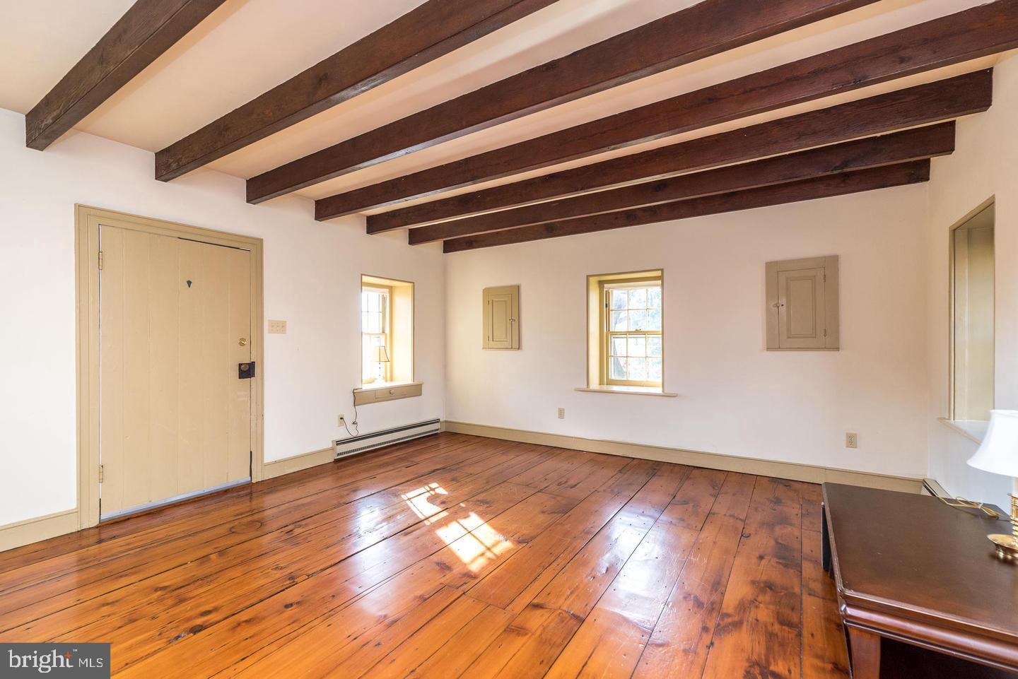 4936 Curly Hill Road Doylestown, PA 18902 - Photo 62 of 102 a view of an empty room with wooden floor and a window