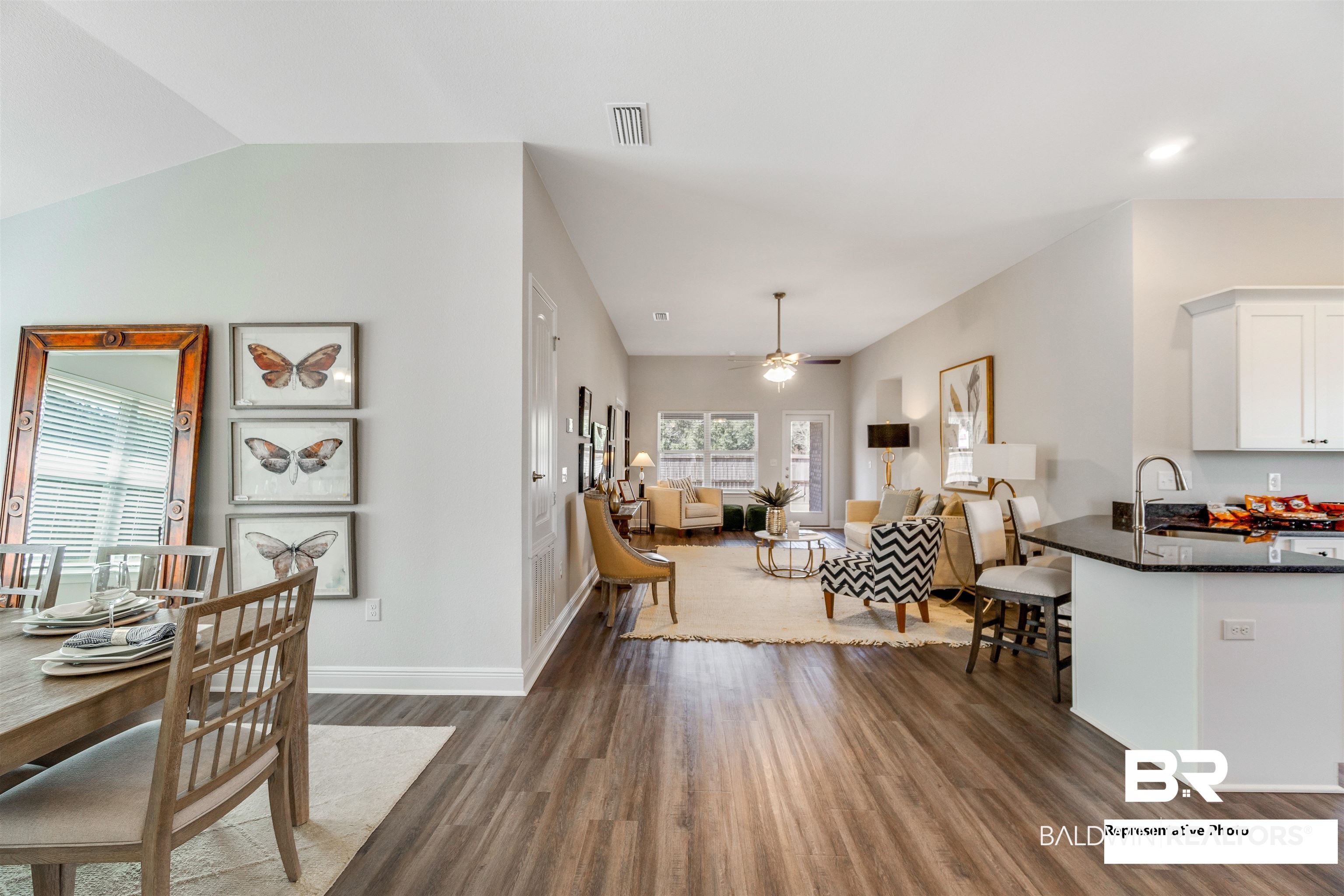 643 Mayflower Drive Foley, AL 36535 - Photo 13 of 34 Dining room with lofted ceiling, ceiling fan, wood finished floors, visible vents, and baseboards