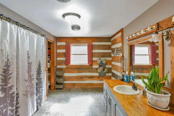 a spacious bathroom with a granite countertop tub and a large window