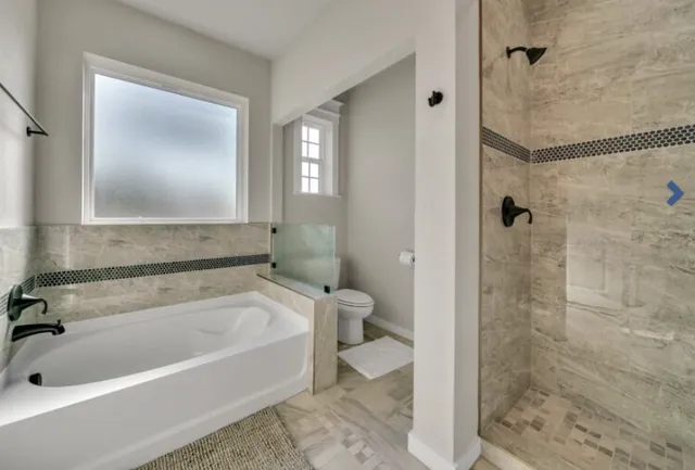a bathroom with a tub and a shower