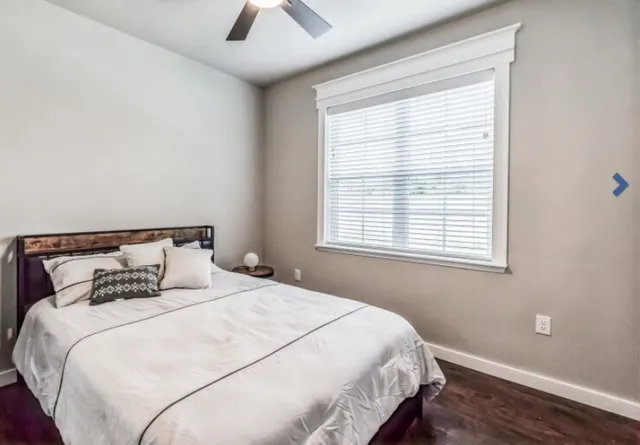 a bedroom with a bed and window