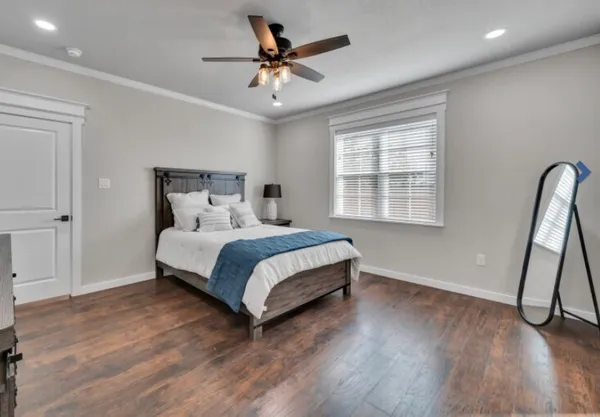 a bedroom with a bed and a window