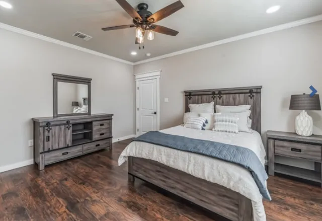 a bedroom with a bed and a chandelier