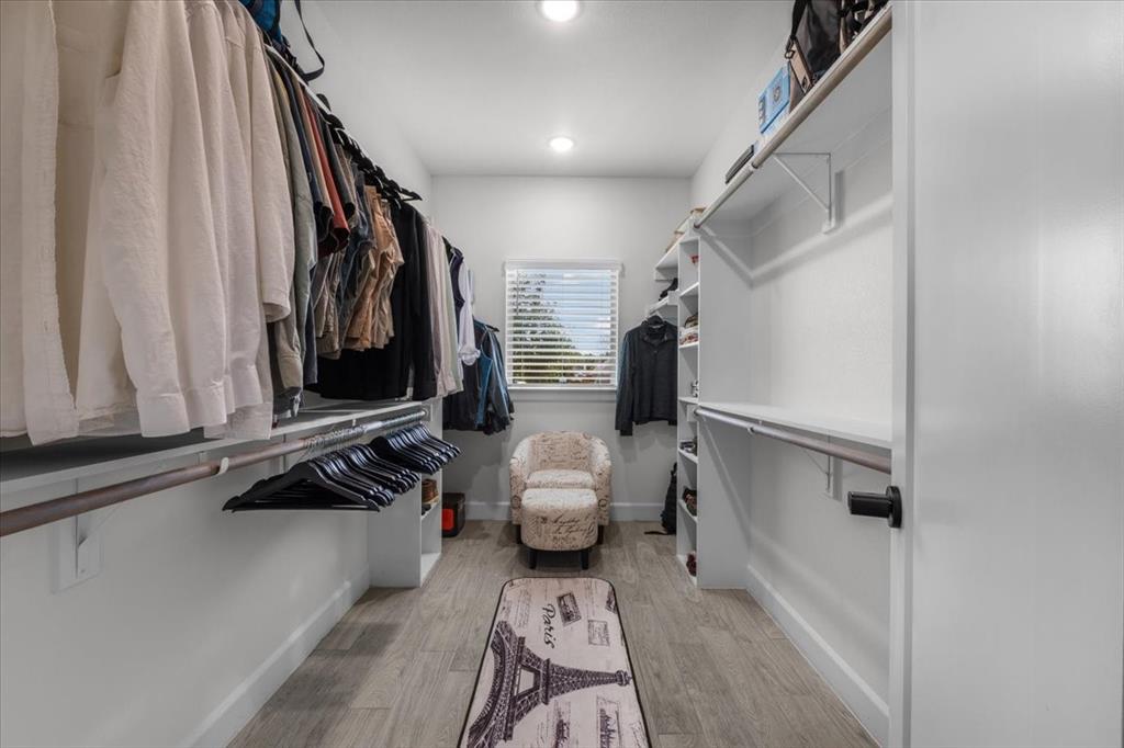 1039 Monaco Court Springtown, TX 76082 - Photo 17 of 33 Walk-in closet featuring built-in shelving and natural light.