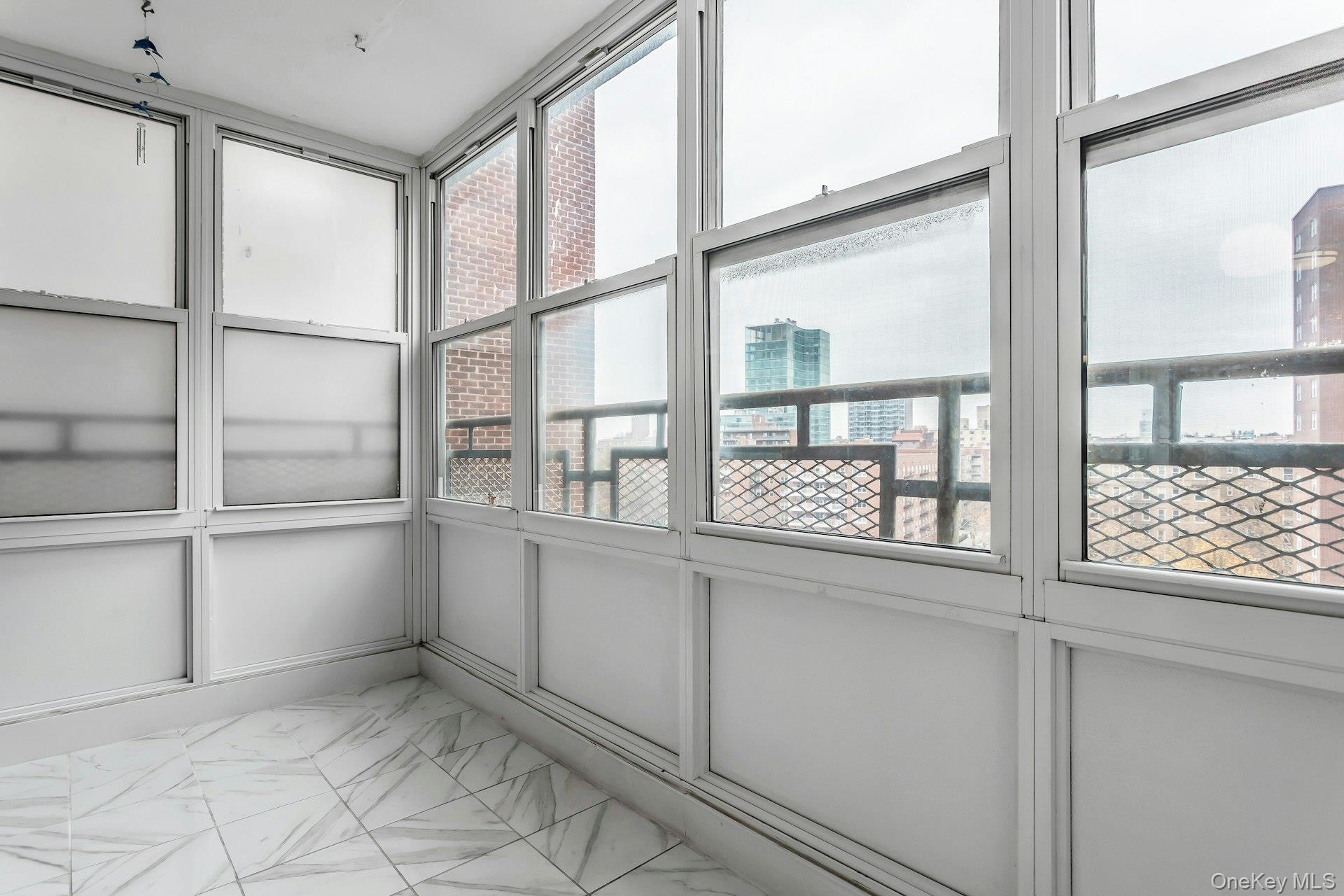 138-10 Franklin Avenue, Unit 9J Queens, NY 11355 - Photo 21 of 25 Unfurnished sunroom featuring a city view