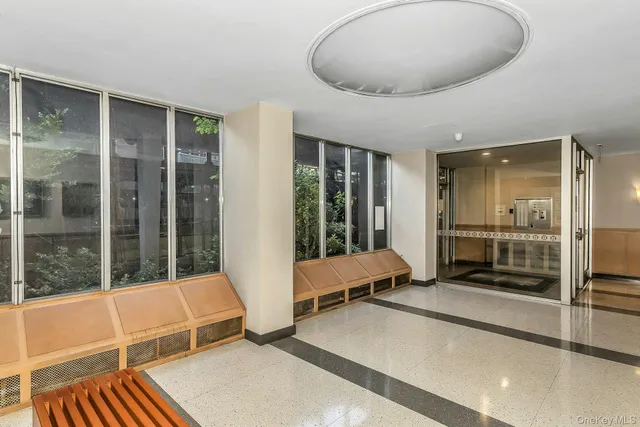 a living room with a large window and furniture
