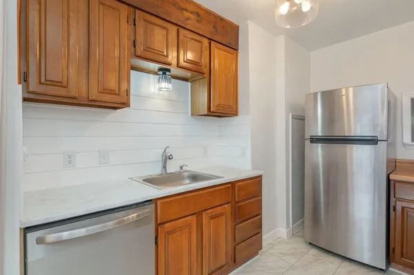 a kitchen with stainless steel appliances granite countertop a refrigerator and a sink