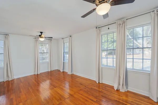 a bedroom with a bed dresser and a window
