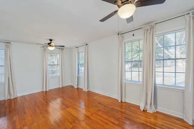 a bedroom with a bed dresser and a window