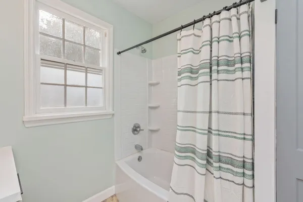 a bathroom with a bathtub and a shower