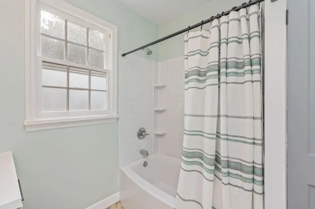 a bathroom with a bathtub and a shower