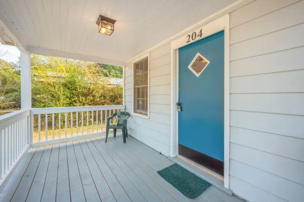 a view of outdoor space with wooden floor and windows