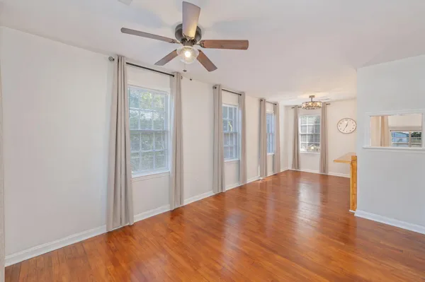 a view of livingroom with hardwood floor and ceiling fan