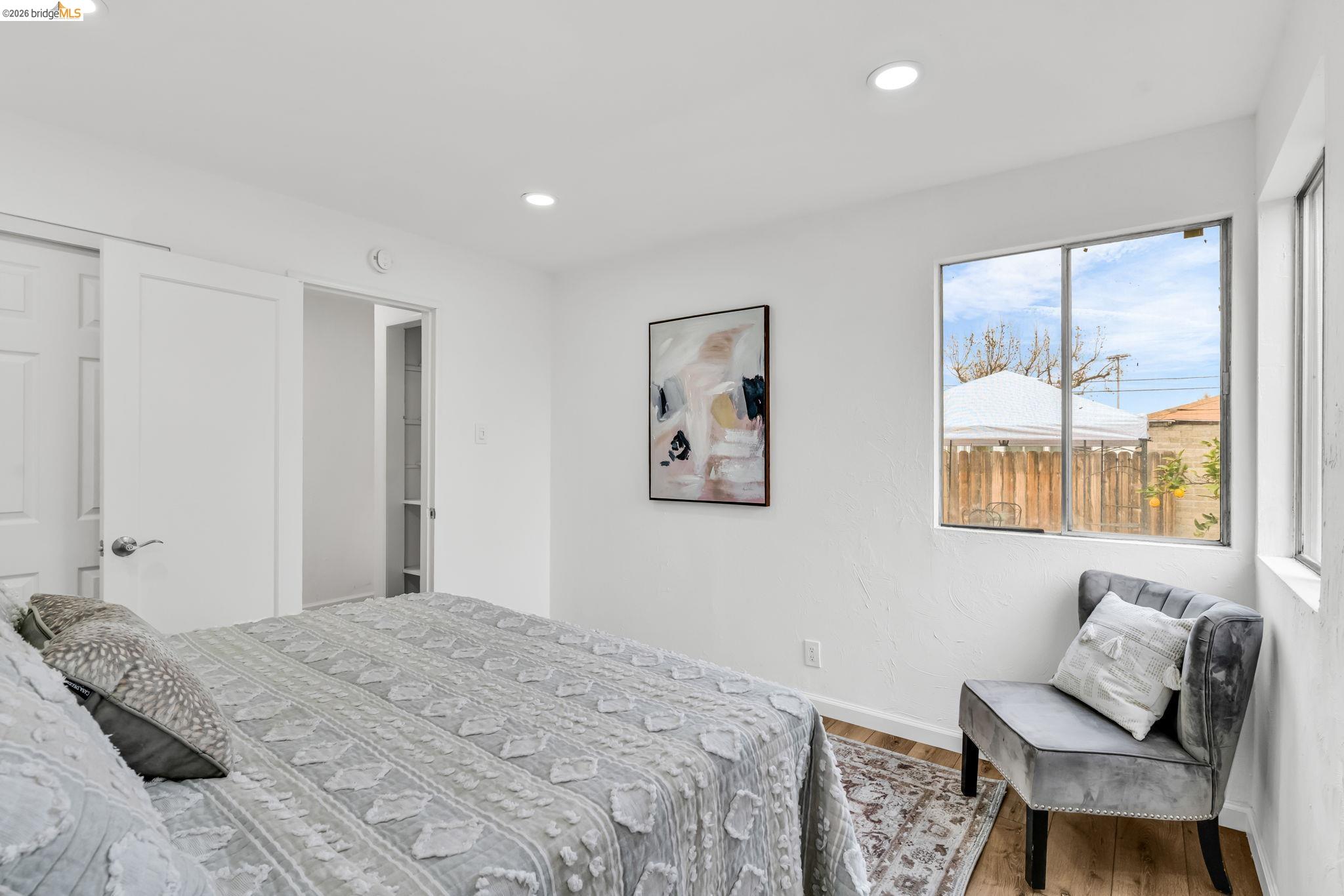 175 Clyde Avenue Pittsburg, CA 94565 - Photo 1 of 1 a bedroom with a bed and wooden floor