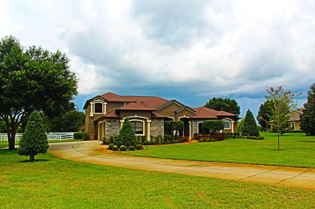 19625 Eagle Run Groveland, FL 34736 - Photo 1 of 1 a front view of a house with a yard