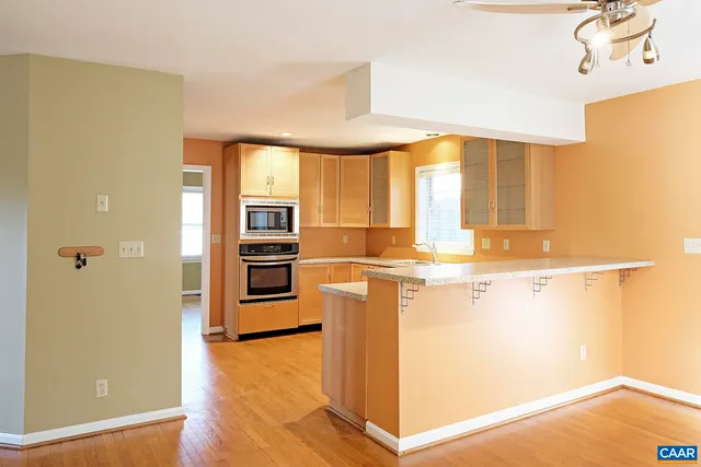 a kitchen with stainless steel appliances a refrigerator and a stove