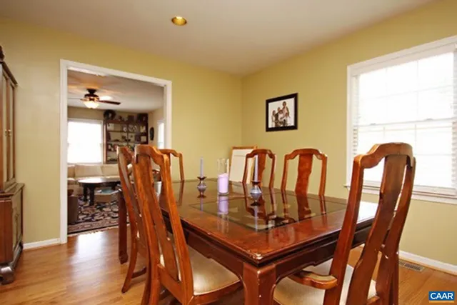 a view of a dining room with furniture and wooden floor